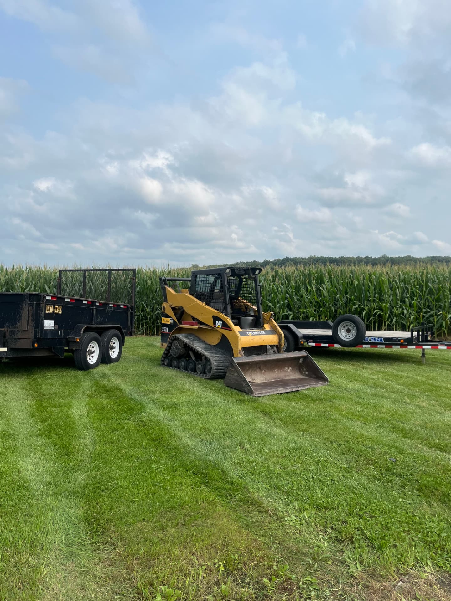 Caterpillar track loader and trailers ready for a property job
